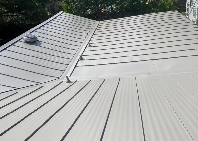 Solar attic fan installed on a metal roof for Roof Ventilation in Wilmington